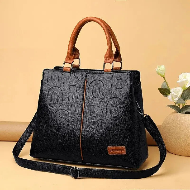 Ladies' handbag in soft leather with embossed letter design