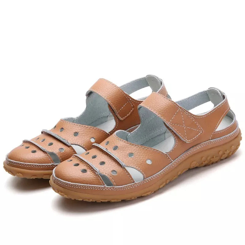 Flat sandals in hollowed-out leather