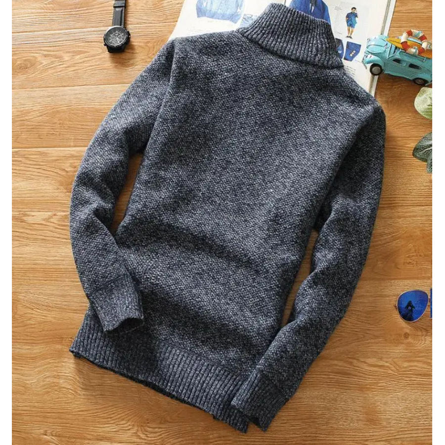 Warming knitted pullover with stand-up collar and zip fastening