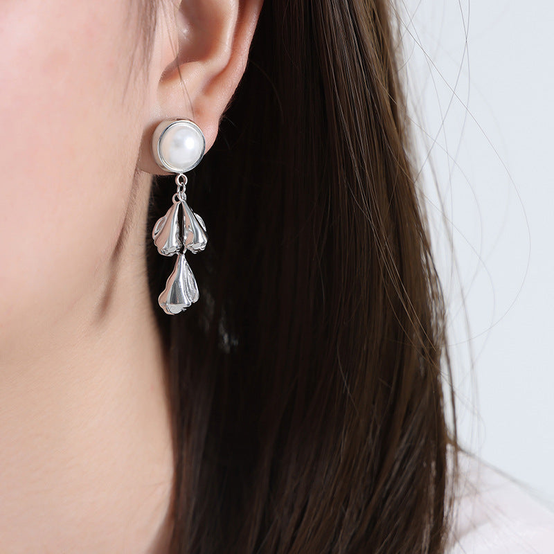 Pearl stud earrings with textured teardrop pendants