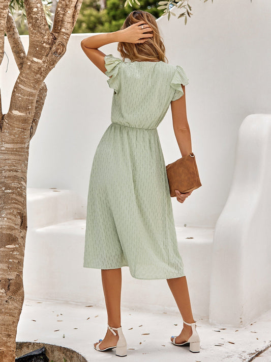 Light green mid-length dress with V-neckline