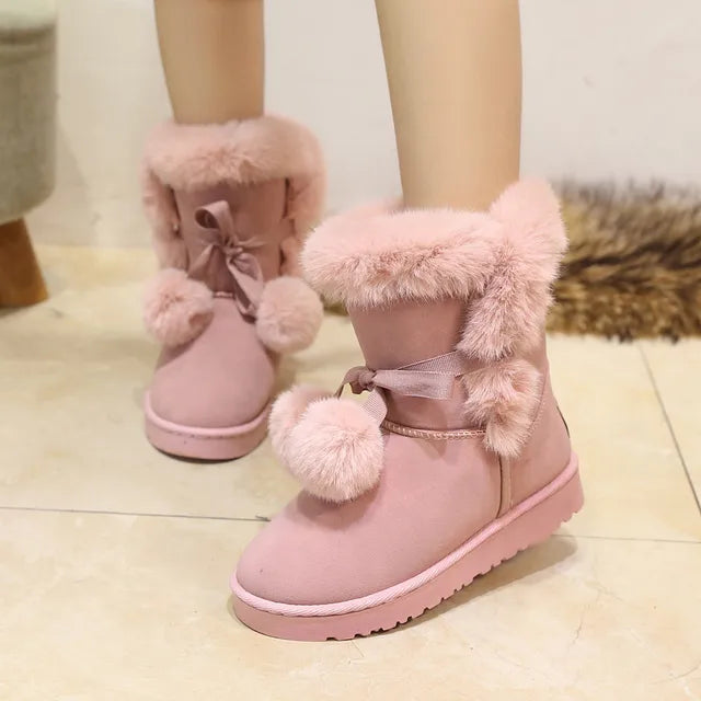 Elegant winter boots with pompom embellishment