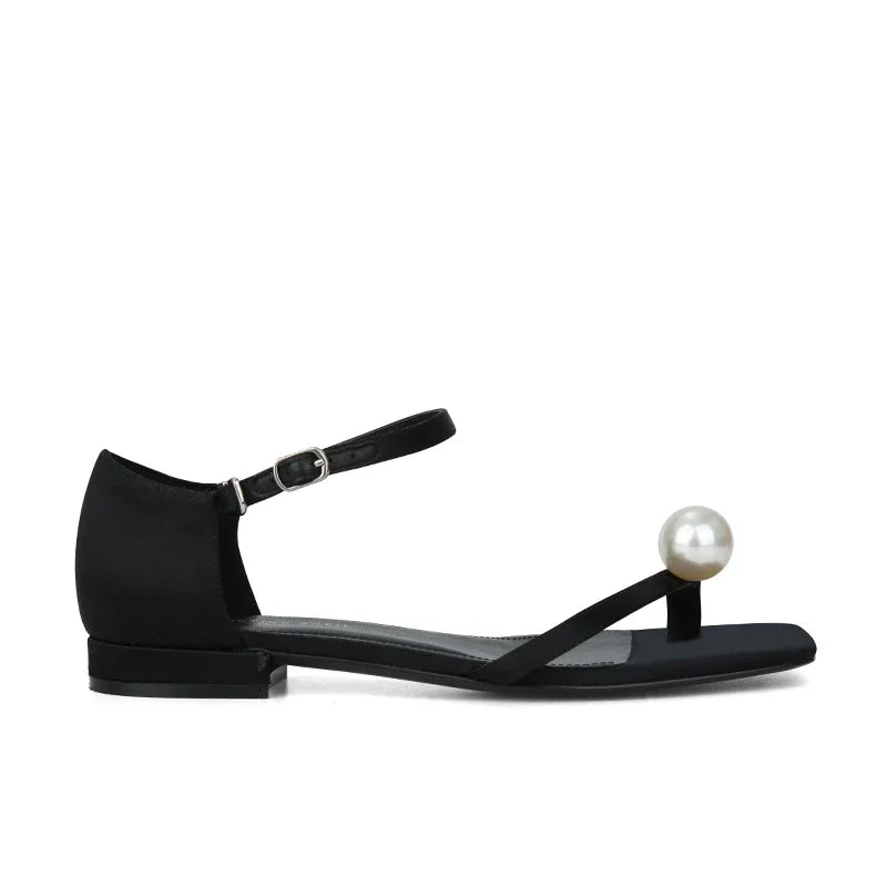 Flat sandals with pearl embellishment