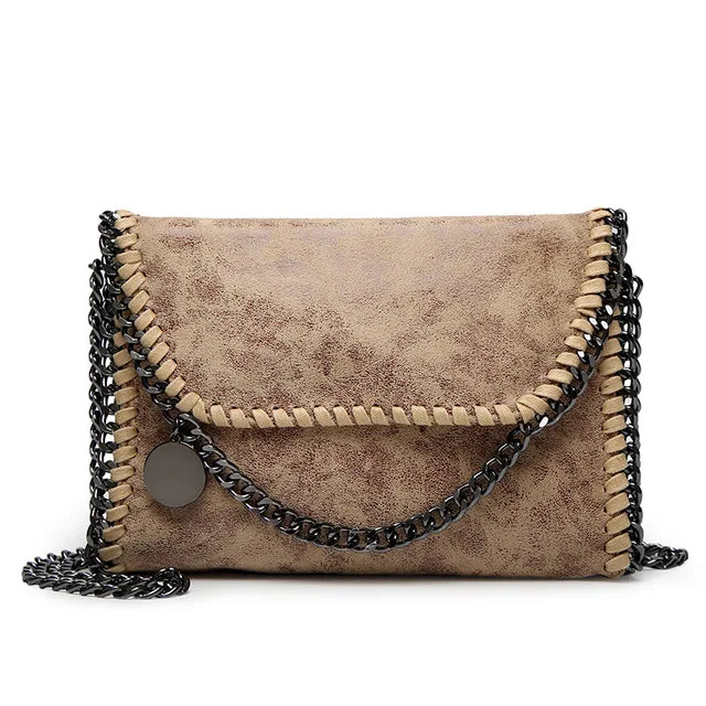 Suede clutch with chain embellishment