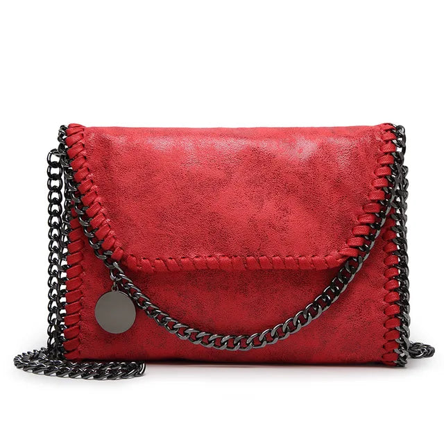 Suede clutch with chain embellishment