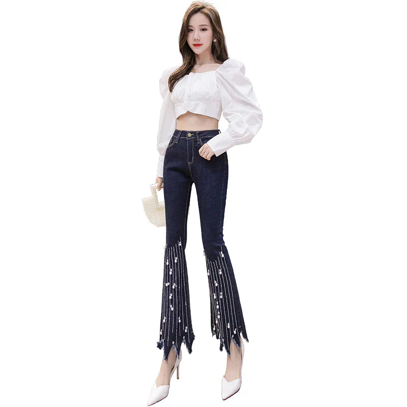 High-waist flare jeans with pearl tassel detail